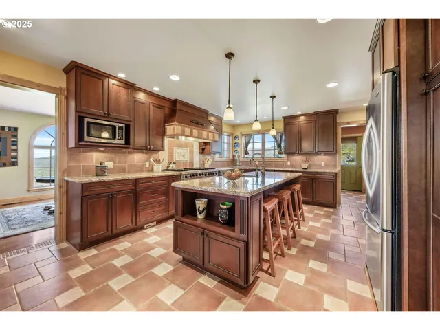 a living room with furniture a fireplace and a chandelier