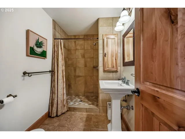 a spacious bedroom with a bed a table and chair