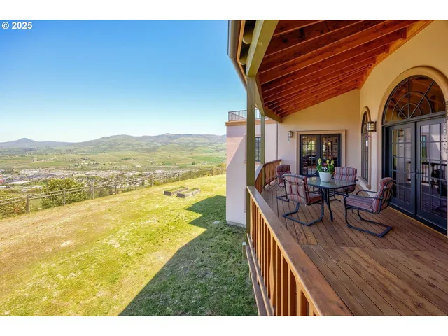 a spacious bedroom with a large bed and a chandelier