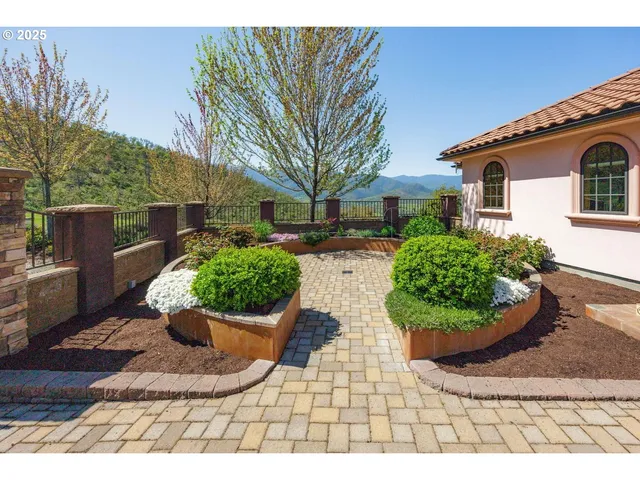a front view of a house with a yard and fountain