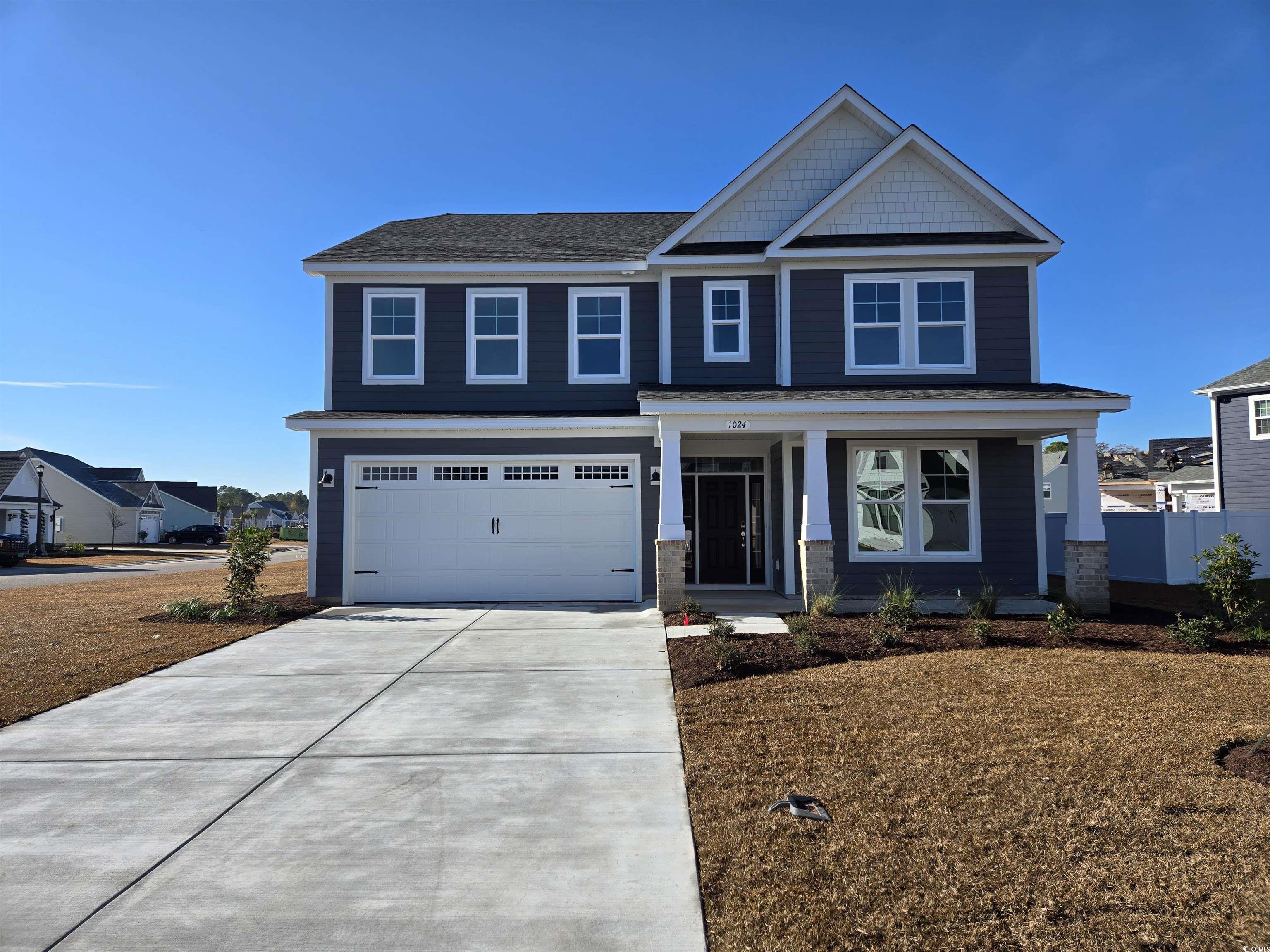 1024 Gold Dew Way Myrtle Beach, SC 29579 - Photo 1 of 10 Craftsman-style home featuring covered porch, concrete driveway, an attached garage, and roof with shingles