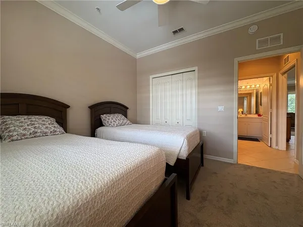 a bedroom with two beds and painted walls