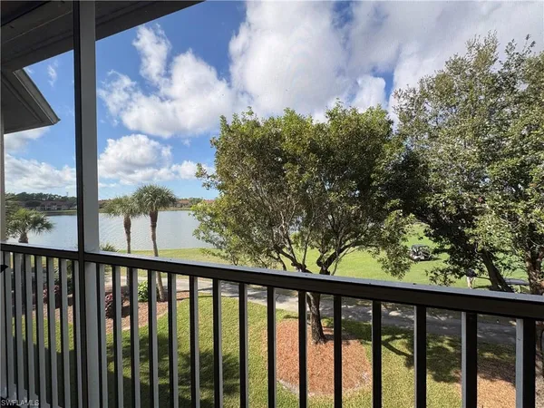 a view of a balcony with wooden fence and floor
