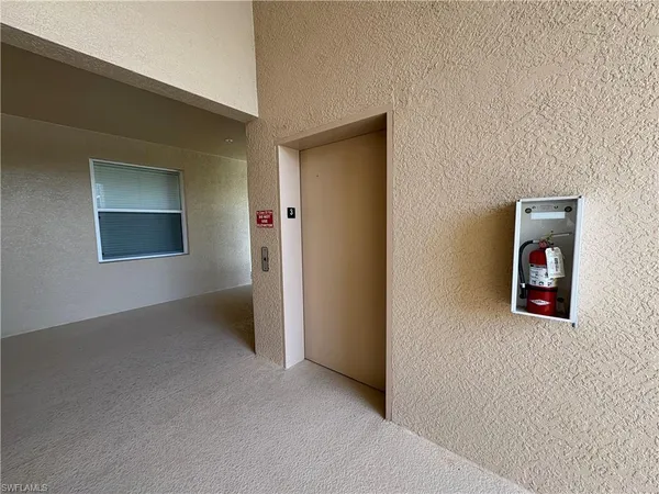 an empty room with painting on the wall