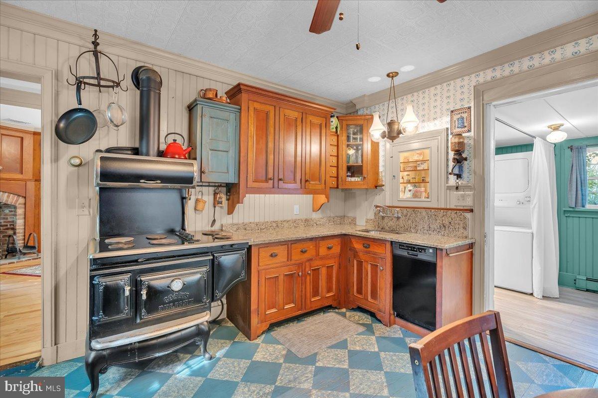 56 Main Street Port Republic, NJ 08241 - Photo 14 of 44 a kitchen with stainless steel appliances granite countertop a stove a sink and a microwave
