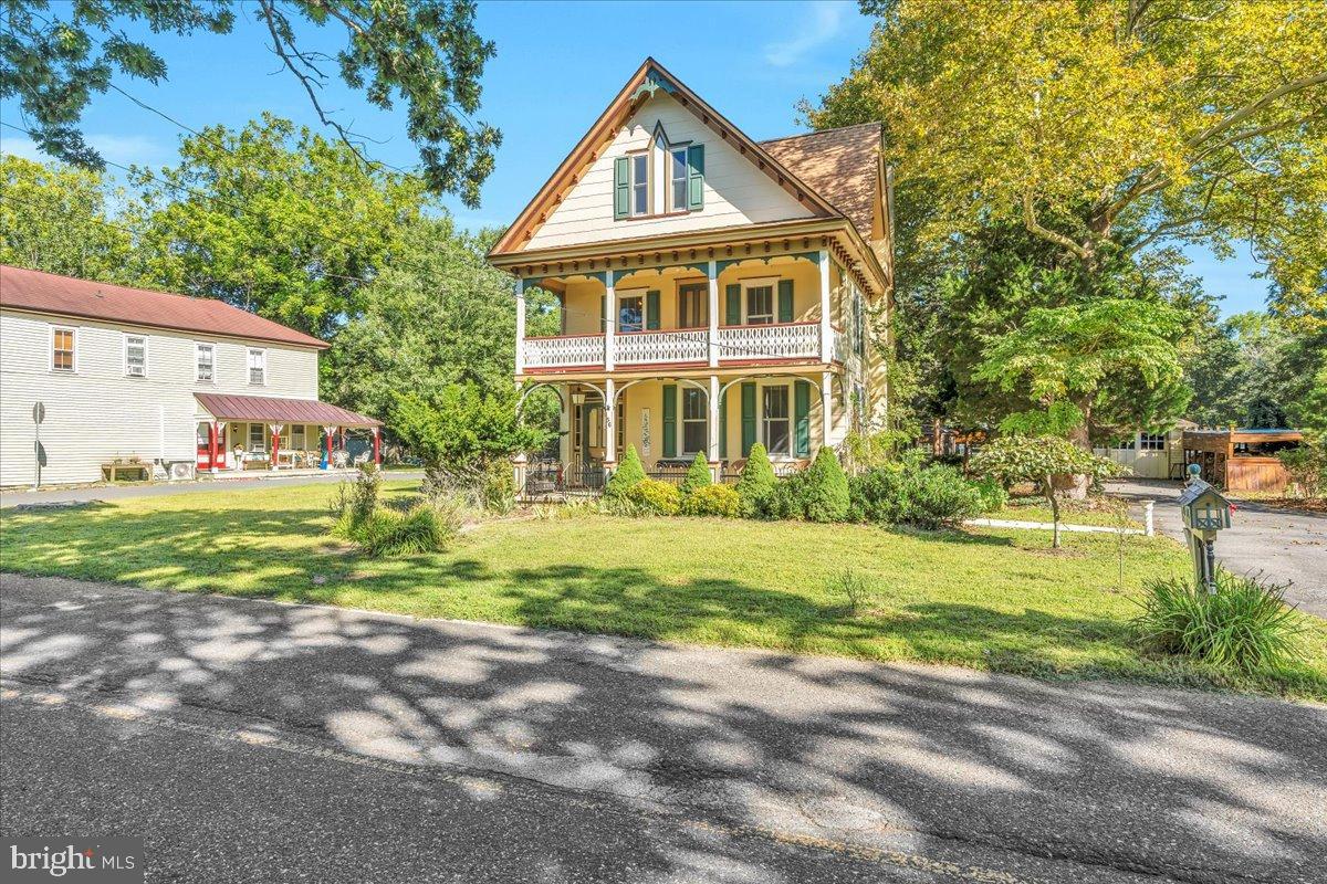 56 Main Street Port Republic, NJ 08241 - Photo 2 of 44 a front view of a house with a yard and trees