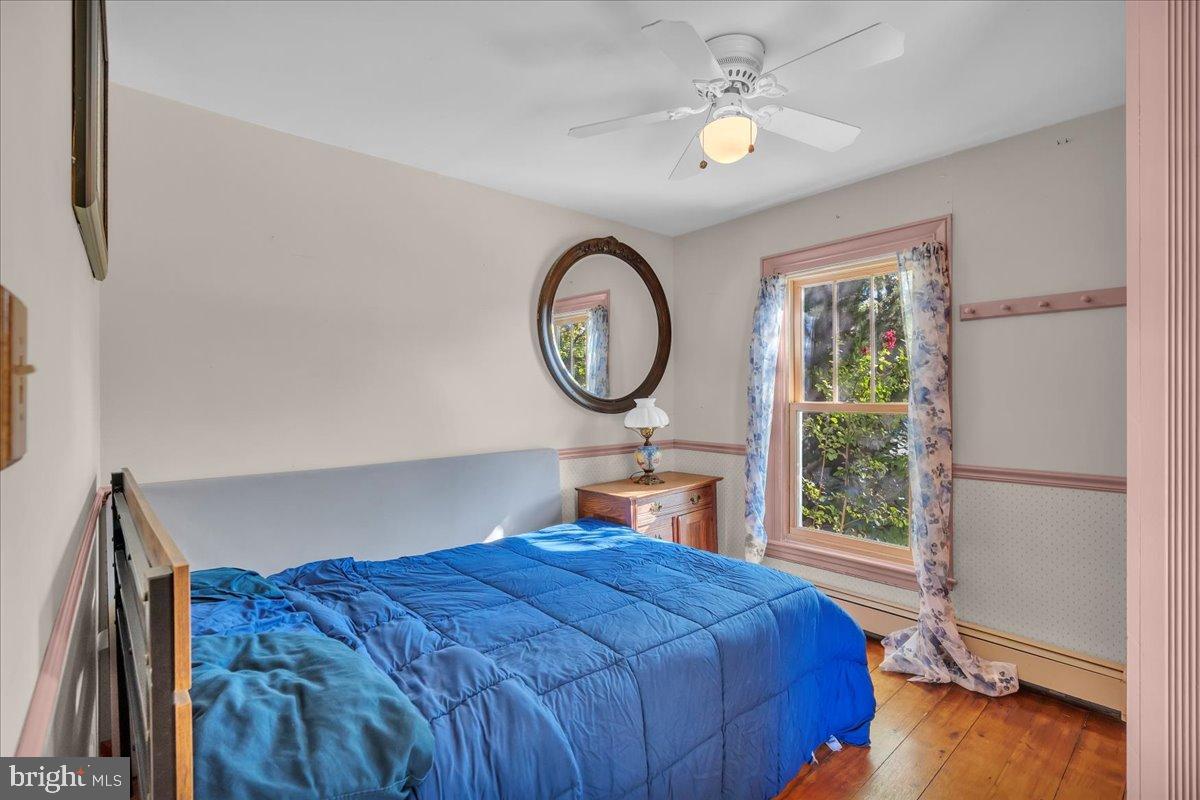 56 Main Street Port Republic, NJ 08241 - Photo 23 of 44 a bedroom with a bed chandelier and a window