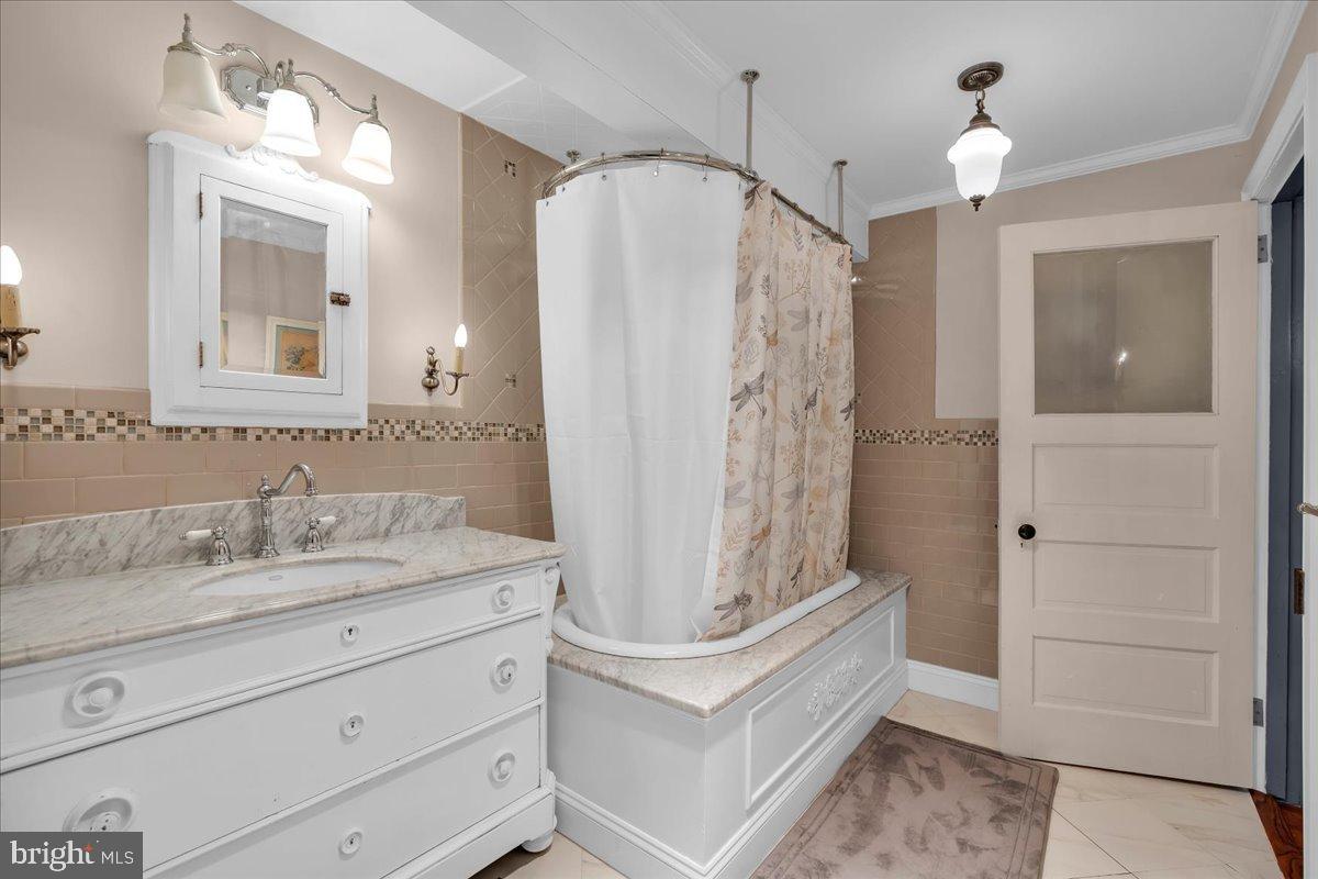 56 Main Street Port Republic, NJ 08241 - Photo 27 of 44 a bathroom with a double vanity sink mirror and shower