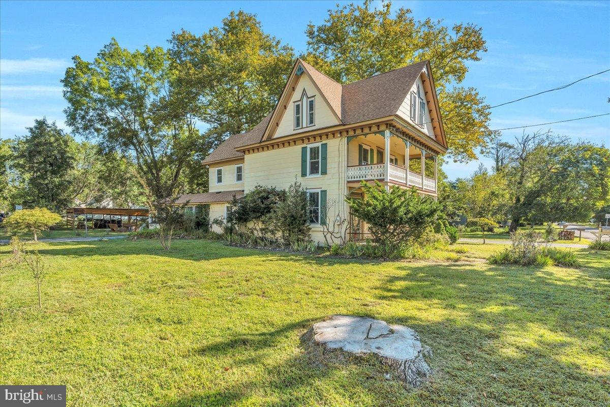 56 Main Street Port Republic, NJ 08241 - Photo 4 of 44 a front view of house with yard and trees around