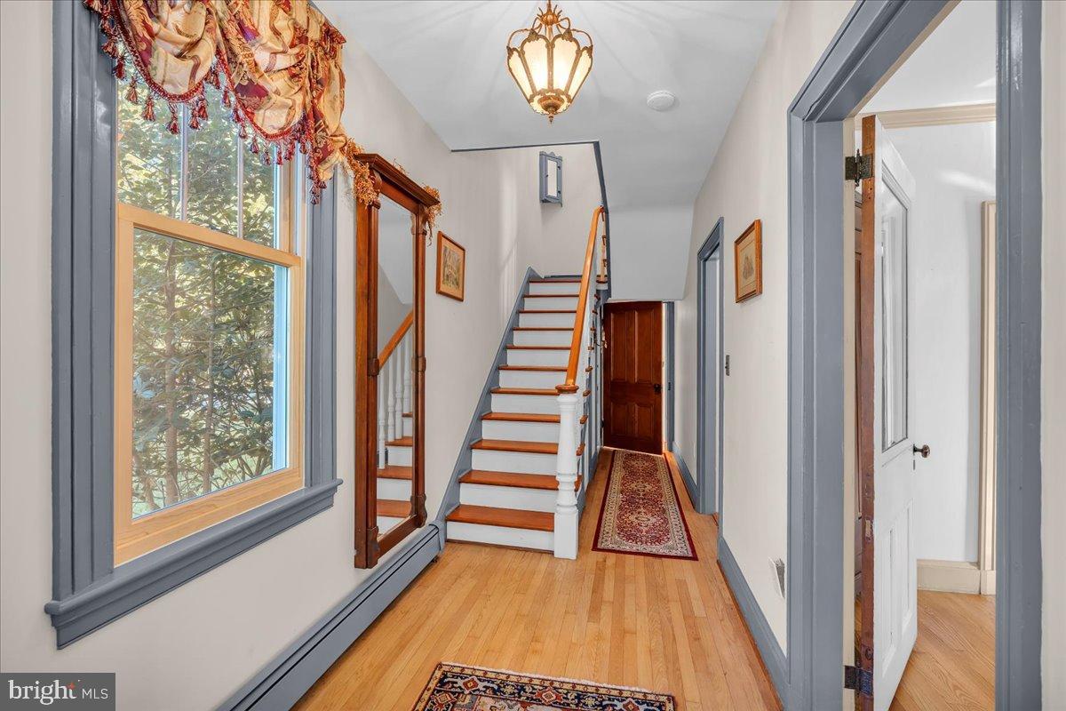 56 Main Street Port Republic, NJ 08241 - Photo 10 of 44 a view of a hallway with wooden floor and staircase