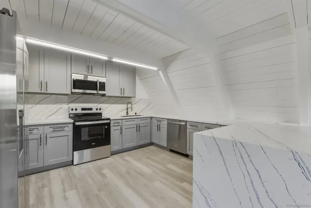 a kitchen with a sink cabinets and stainless steel appliances