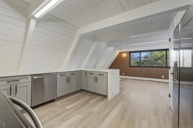 a view of a kitchen with a sink and a window