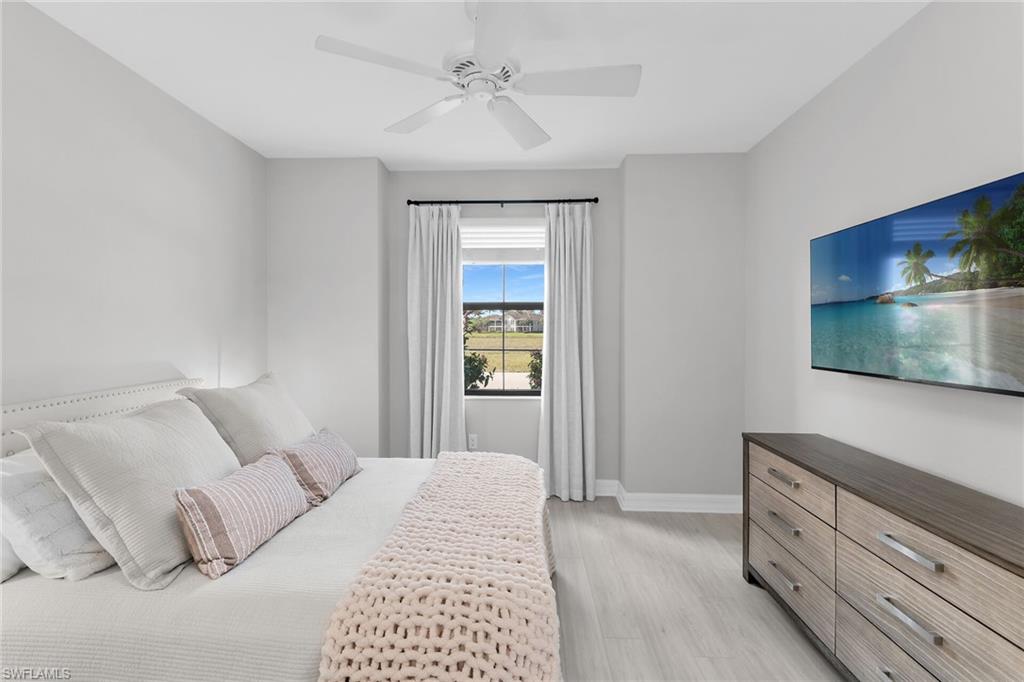 2926 Aviamar Circle Naples, FL 34114 - Photo 18 of 44 Bedroom with light wood-type flooring and a ceiling fan