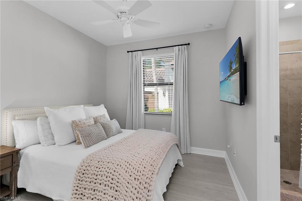 2926 Aviamar Circle Naples, FL 34114 - Photo 20 of 44 Bedroom with a ceiling fan and light wood finished floors