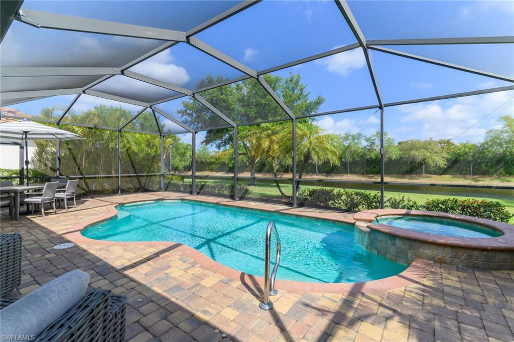 2926 Aviamar Circle Naples, FL 34114 - Photo 27 of 44 Integrated pool / spa with a sunroom, outdoor dining area, a lanai, and a patio area