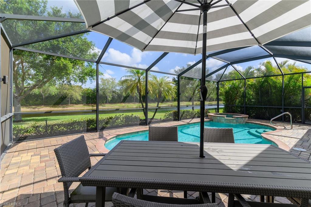 2926 Aviamar Circle Naples, FL 34114 - Photo 28 of 44 Integrated pool / spa with a patio area, a sunroom, a lanai, and a water view