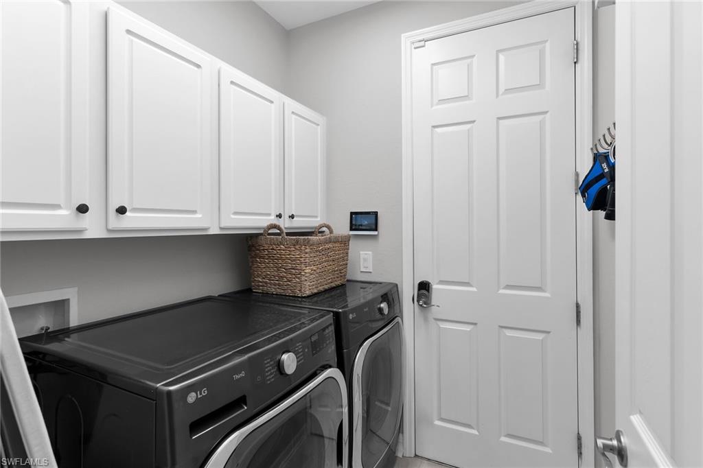 2926 Aviamar Circle Naples, FL 34114 - Photo 29 of 44 Laundry room featuring cabinet space and washing machine and dryer
