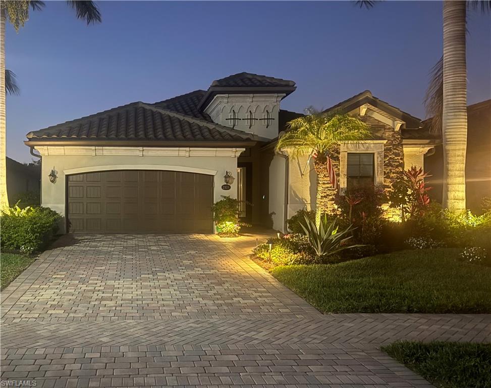 2926 Aviamar Circle Naples, FL 34114 - Photo 32 of 44 Mediterranean / spanish home with an attached garage, decorative driveway, stone siding, and stucco siding