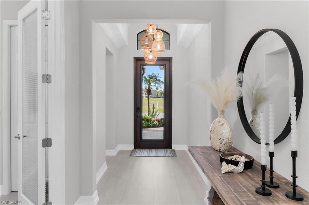2926 Aviamar Circle Naples, FL 34114 - Photo 8 of 44 Entrance foyer with a chandelier and light wood-style flooring