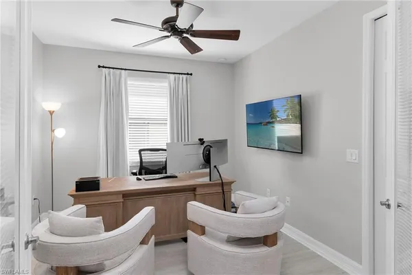 a kitchen with stainless steel appliances kitchen island granite countertop a table chairs refrigerator and microwave