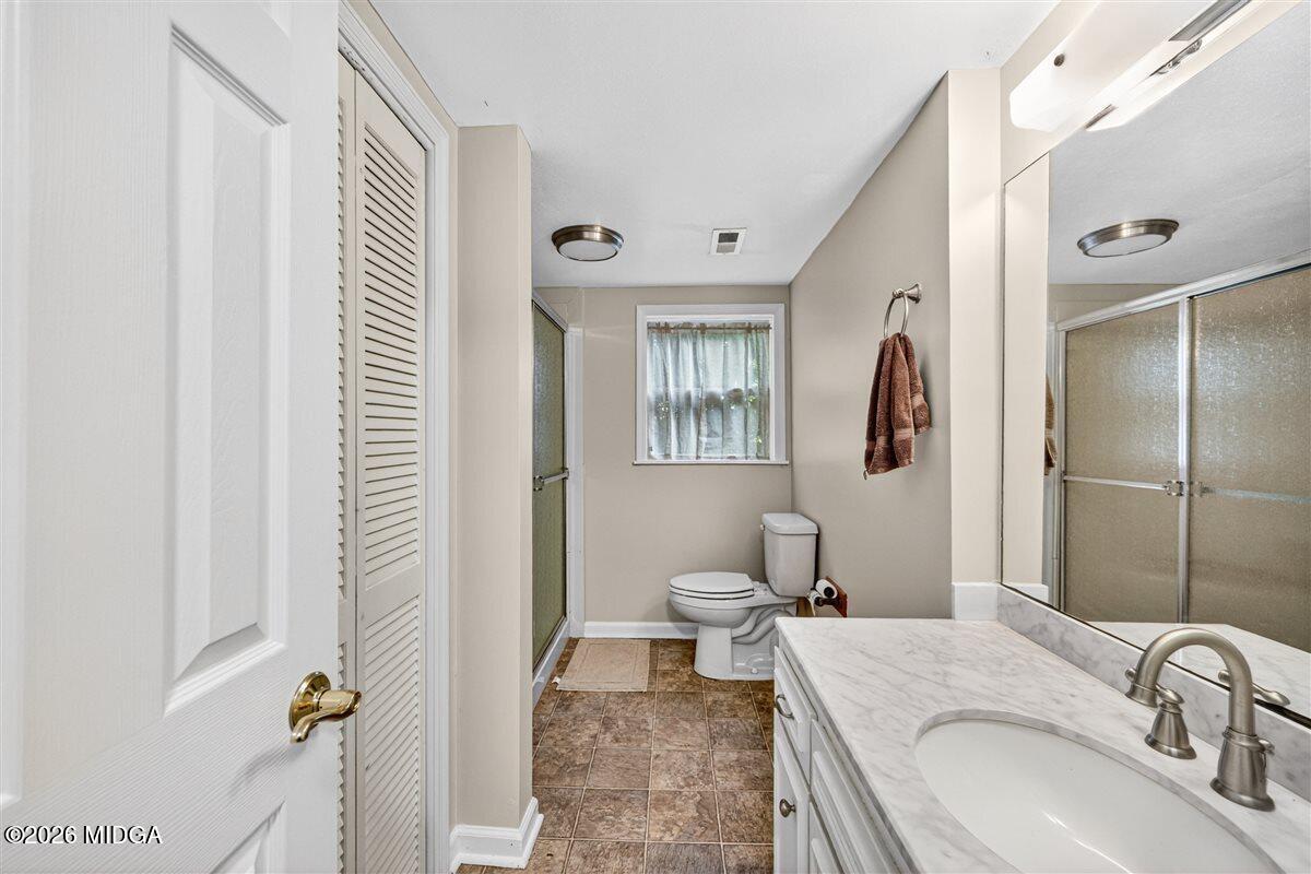 335 Hamrick Road Macon, GA 31220 - Photo 20 of 41 a bathroom with a granite countertop sink and a mirror
