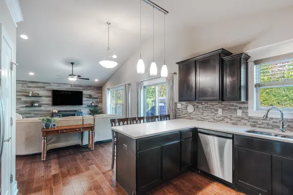 a kitchen with kitchen island a sink and a large window
