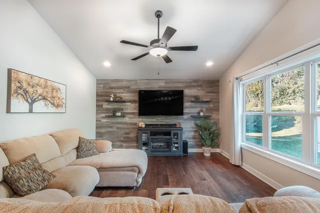a living room with furniture a flat screen tv and a fireplace