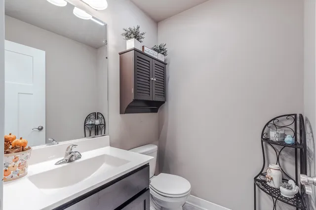 a bathroom with a sink toilet and mirror