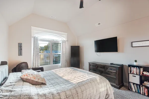 a bedroom with a bed and a flat screen tv