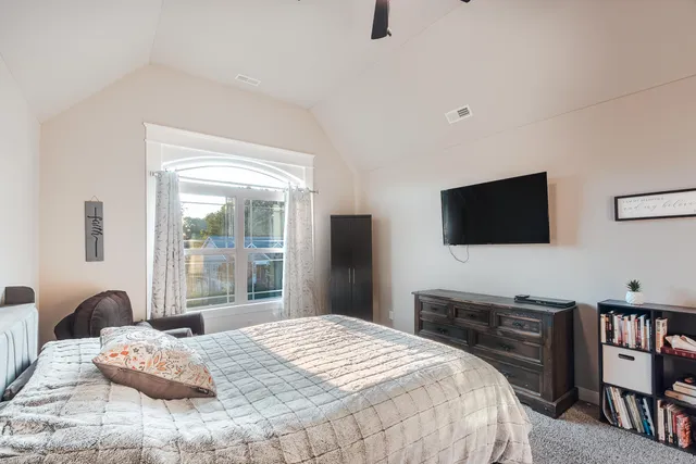 a bedroom with a bed and a flat screen tv