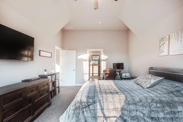 a bedroom with a bed and a flat screen tv
