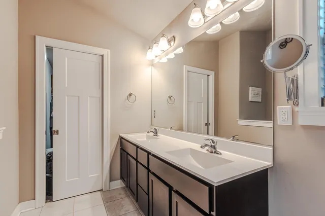 a bathroom with a sink a mirror and a light fixture