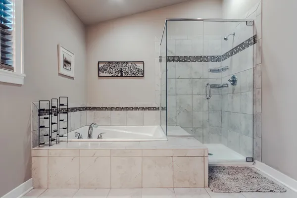 a bathroom with a bathtub and a shower