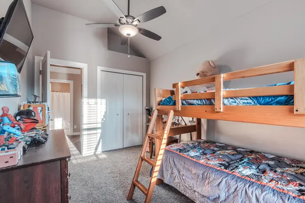 a bedroom with a bed and a chandelier
