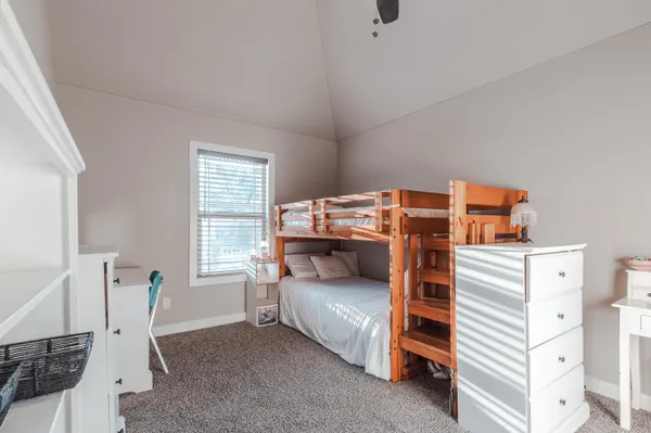 a bedroom with a bed and a chair