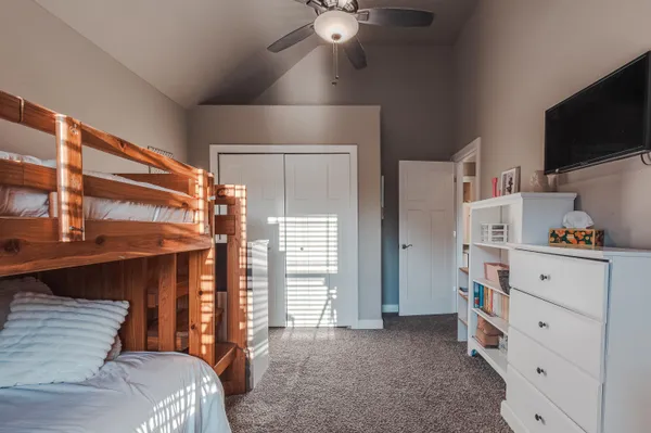 a bedroom with a bed and flat screen tv