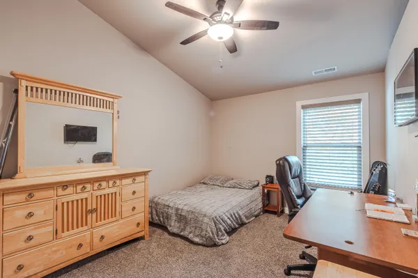 a bedroom with a bed and a desk