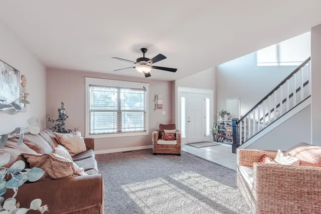 a living room with furniture and large windows