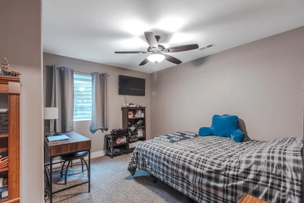 a bedroom with a bed and a chandelier