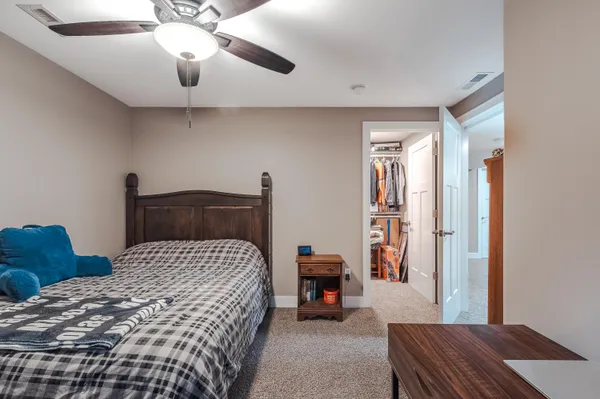 a bedroom with a bed and a chandelier