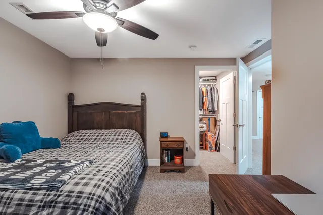 a bedroom with a bed and a chandelier