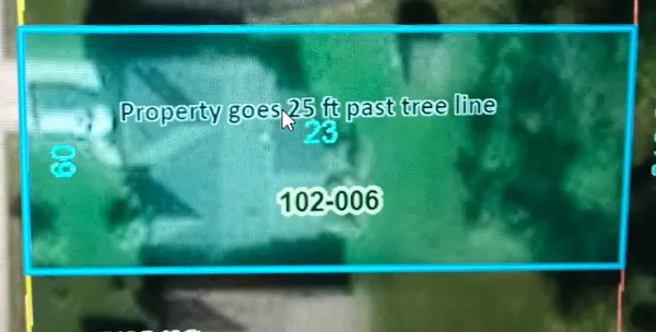 a view of a chair and table in the back yard