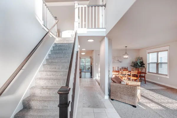 a view of entryway and hall with wooden floor