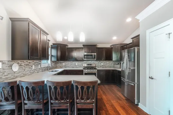 a kitchen with kitchen island a large counter and chairs