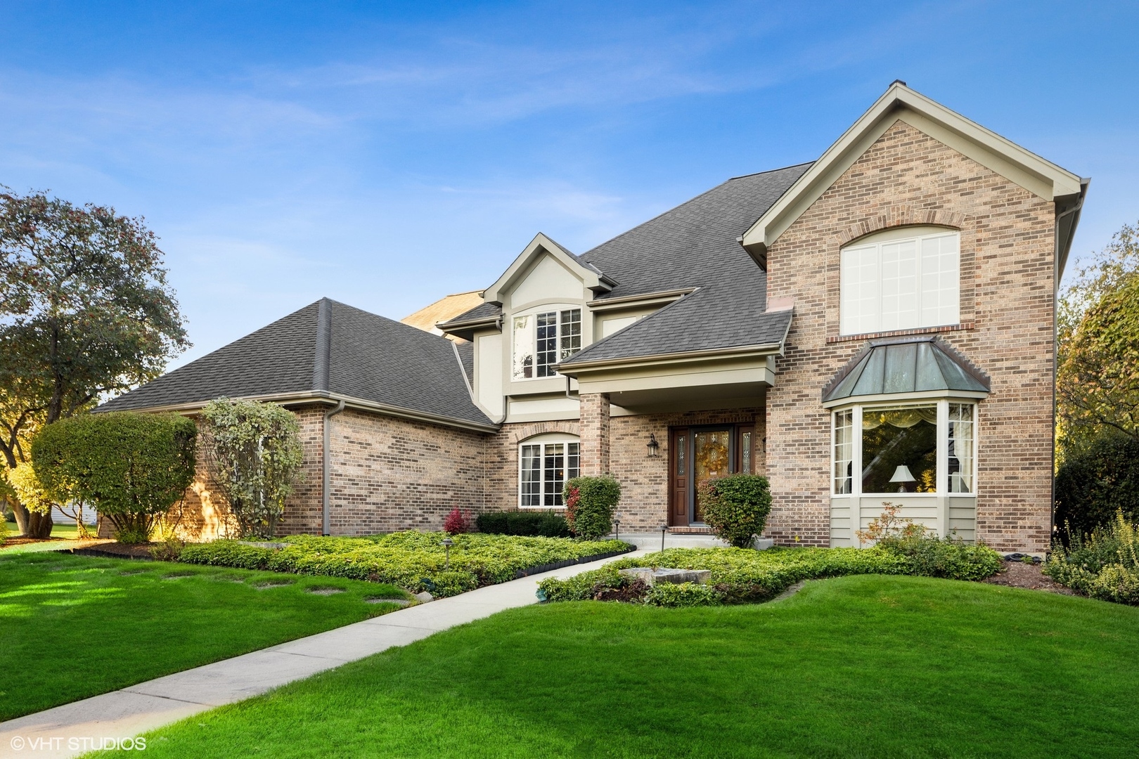 a front view of a house with a yard