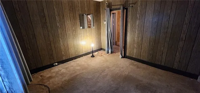 a view of staircase with wooden floor and white walls