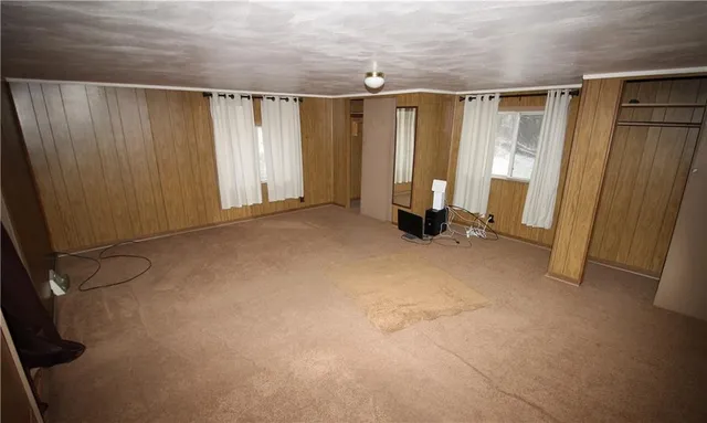 a view of a hallway with wooden shelves