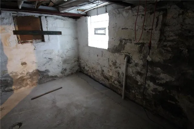 a view of a small house with a yard covered in snow