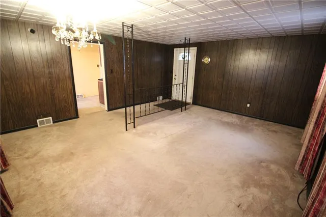 a view of a hallway with wooden walls