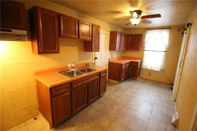 a kitchen with a stove a refrigerator and a sink